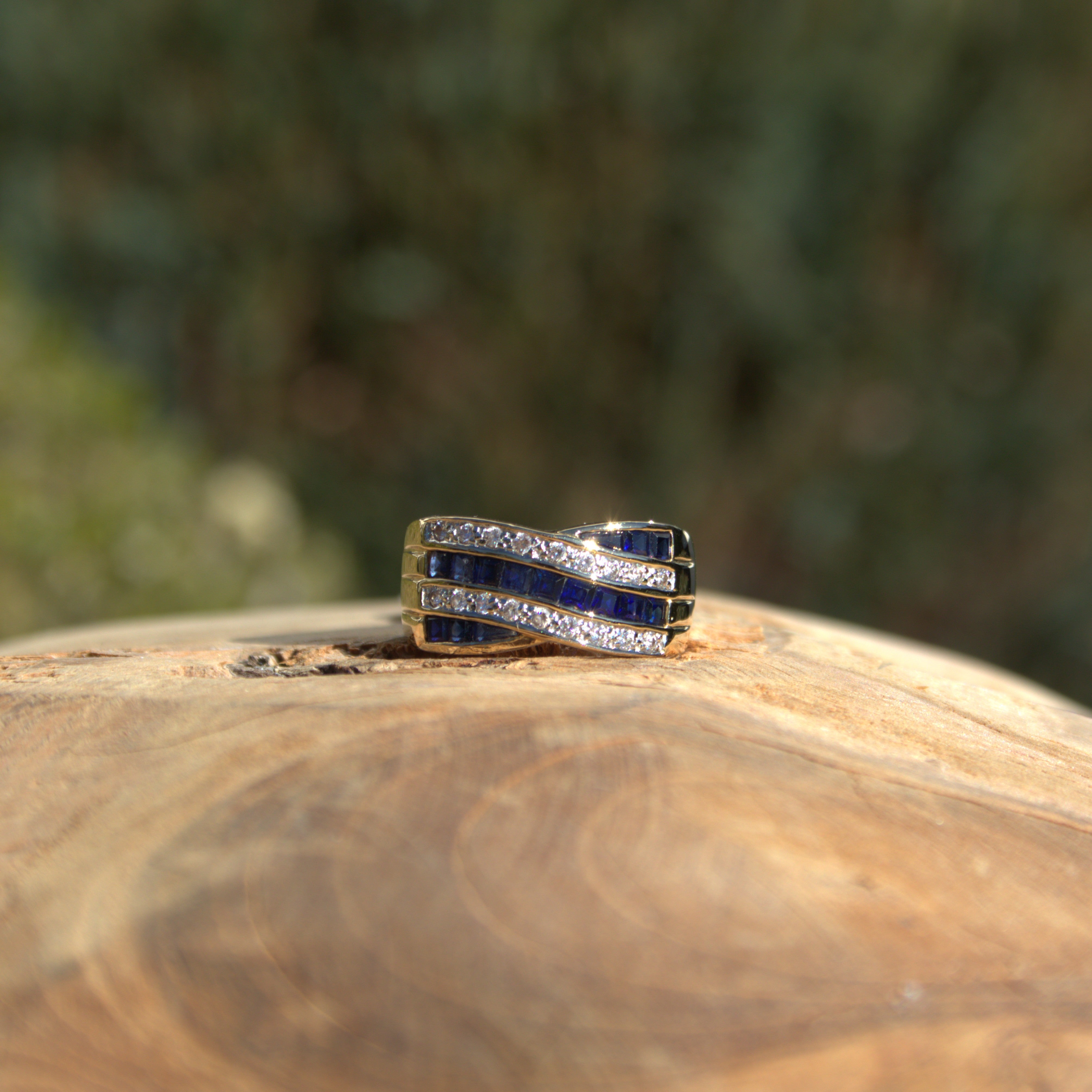 Een statement sieraad weergegeven. Vier banen in een geelgouden ring van diamanten en edelstenen. Ontdek alle statement sieraden bij Clary.